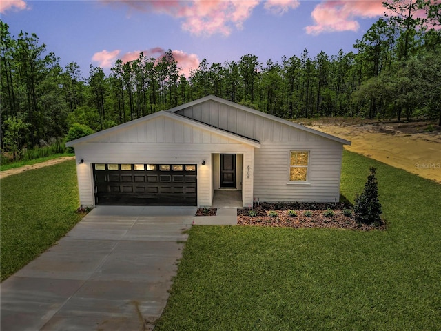 6106 SW 127 Avenue Rd, Ocala, FL 34481 - view of front of property featuring board and batten siding, concrete driveway, an attached garage, and a front yard