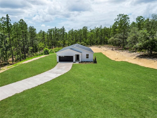 6106 SW 127 Avenue Rd, Ocala, FL 34481 - view of grassy yard with a forest view and driveway