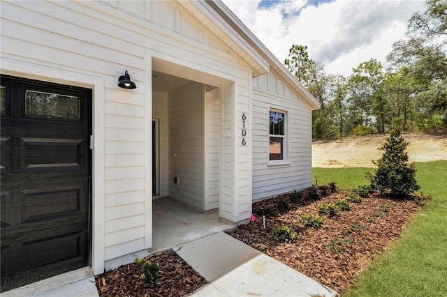 6106 SW 127 Avenue Rd, Ocala, FL 34481 - doorway to property with board and batten siding