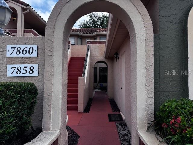 7858 Sugar View Ct Unit 7858, Orlando, FL 32819 - doorway to property featuring stucco siding