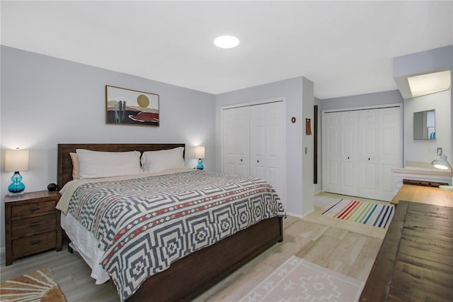 7858 Sugar View Ct Unit 7858, Orlando, FL 32819 - bedroom featuring light wood-style flooring, multiple closets, and baseboards