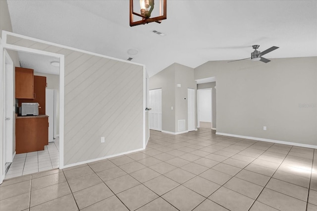3685 Sunday Dr, Deltona, FL 32738 - spare room featuring lofted ceiling, light tile patterned floors, ceiling fan, and baseboards