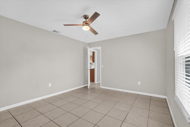 3685 Sunday Dr, Deltona, FL 32738 - spare room featuring a ceiling fan, baseboards, a textured ceiling, and light tile patterned floors