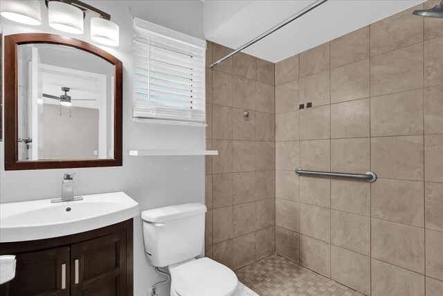 3685 Sunday Dr, Deltona, FL 32738 - bathroom featuring vanity, a tile shower, toilet, and a ceiling fan