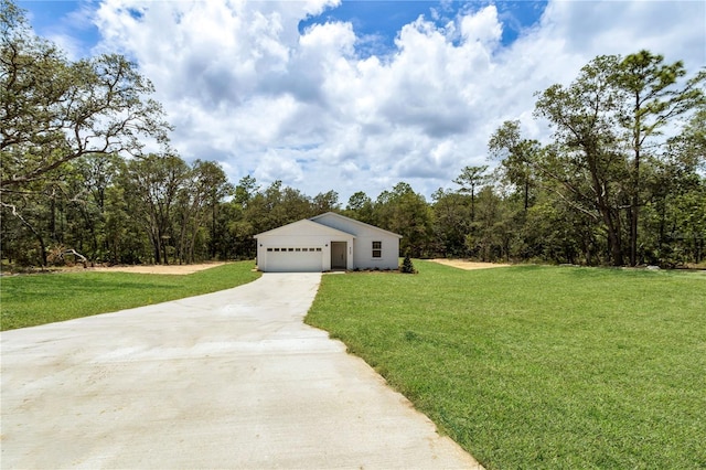 8258 SW 136th Ter, Dunnellon, FL 34432 - detached garage featuring driveway and a forest view