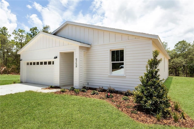 8258 SW 136th Ter, Dunnellon, FL 34432 - view of front of property with a garage, concrete driveway, a front lawn, and board and batten siding