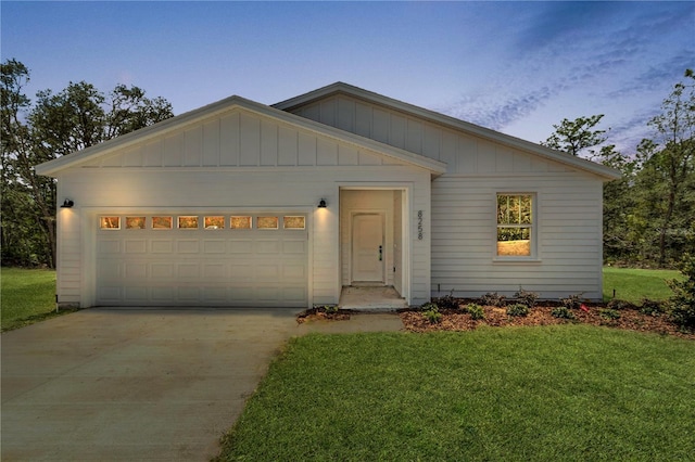 8258 SW 136th Ter, Dunnellon, FL 34432 - view of front facade with a garage, a front lawn, concrete driveway, and board and batten siding