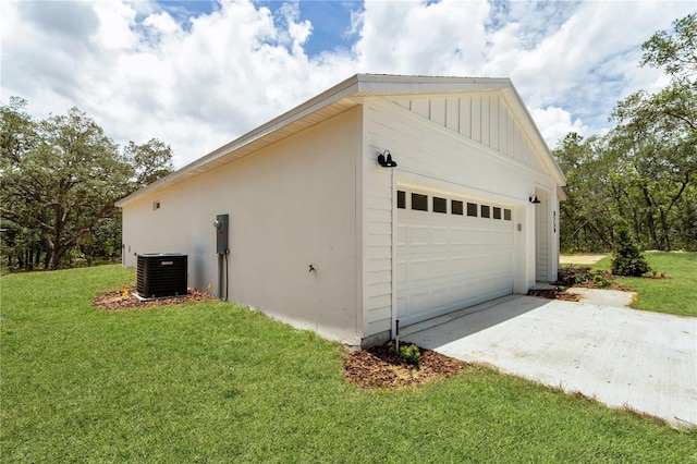 8258 SW 136th Ter, Dunnellon, FL 34432 - view of property exterior featuring a garage, stucco siding, a yard, an outdoor structure, and board and batten siding