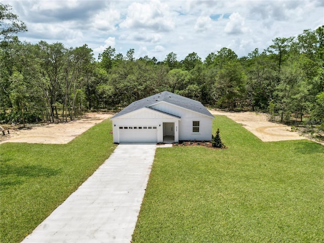 8258 SW 136th Ter, Dunnellon, FL 34432 - view of front of property featuring a front lawn, concrete driveway, and a forest view