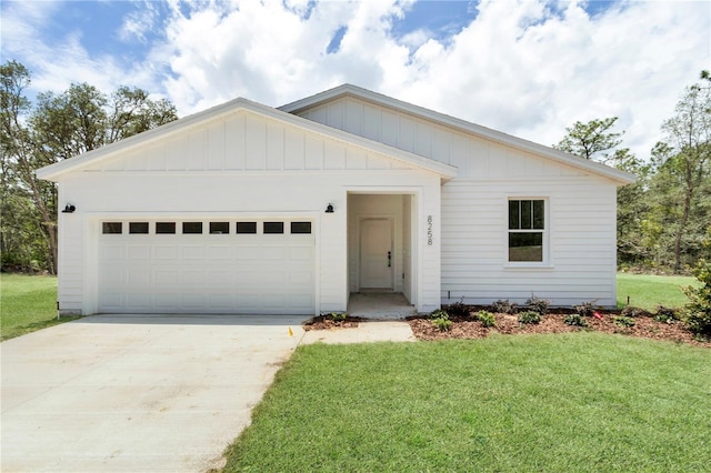 8258 SW 136th Ter, Dunnellon, FL 34432 - view of front facade with a front lawn, an attached garage, concrete driveway, and board and batten siding
