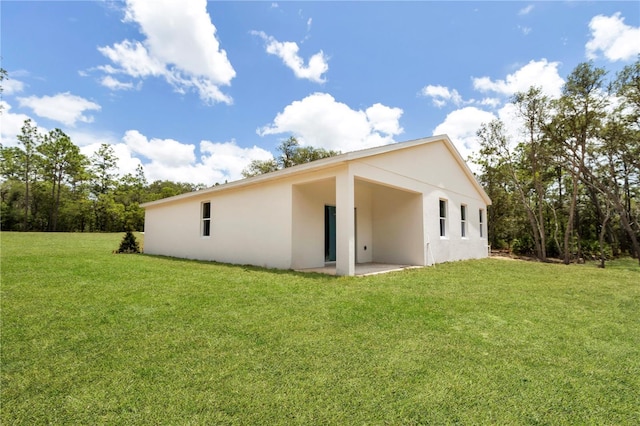 8258 SW 136th Ter, Dunnellon, FL 34432 - rear view of property featuring stucco siding, a yard, and a patio area