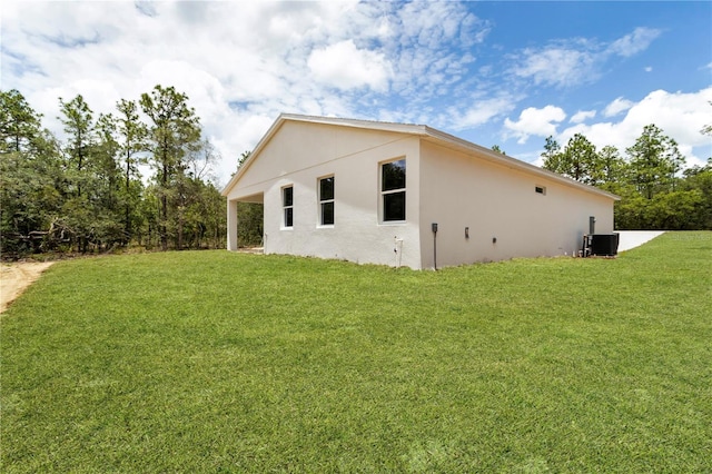 8258 SW 136th Ter, Dunnellon, FL 34432 - view of side of property featuring stucco siding and a lawn