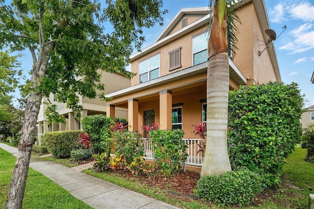 view of front of property with a porch and stucco siding