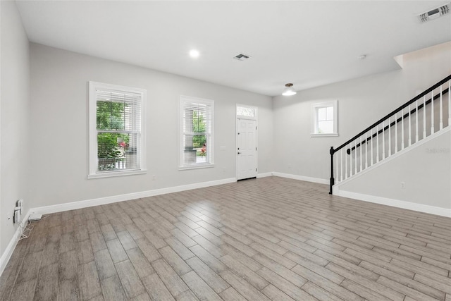 entrance foyer with stairway, wood finished floors, baseboards, and recessed lighting