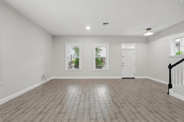 entryway featuring stairway, healthy amount of natural light, wood finished floors, and recessed lighting