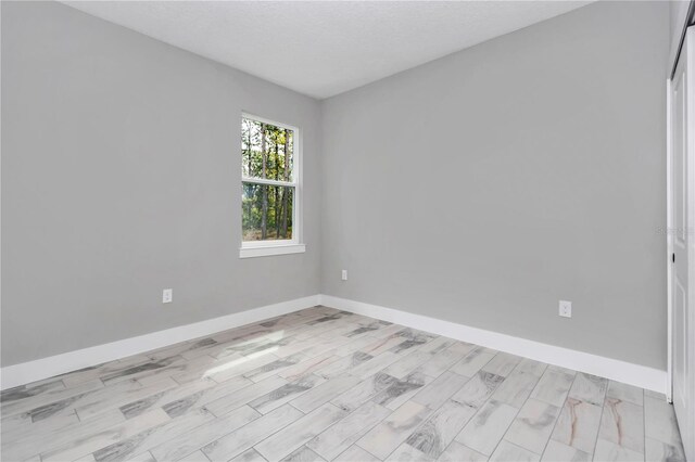 13101 SW 85th Pl, Dunnellon, FL 34432 - unfurnished room featuring baseboards and light wood-style floors