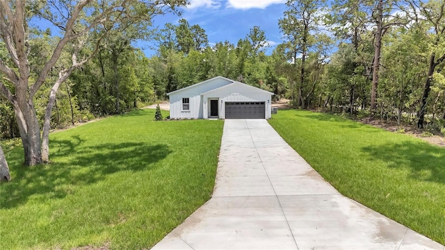13101 SW 85th Pl, Dunnellon, FL 34432 - view of front of house with a garage, a front yard, driveway, and a wooded view