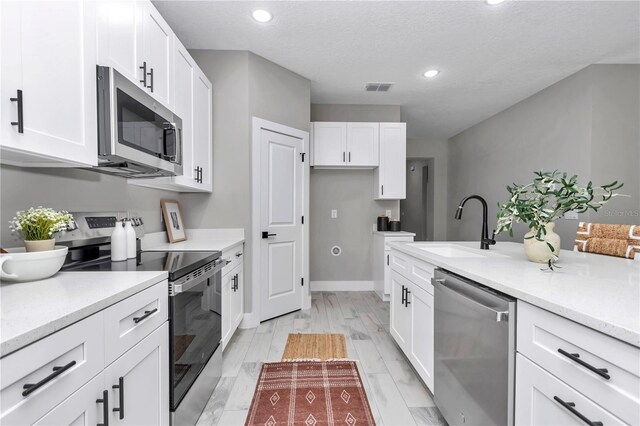 9695 SW 125 Court Rd, Dunnellon, FL 34432 - kitchen featuring appliances with stainless steel finishes, a sink, white cabinetry, and recessed lighting