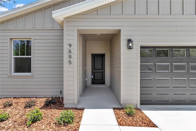 9695 SW 125 Court Rd, Dunnellon, FL 34432 - doorway to property with board and batten siding and a garage