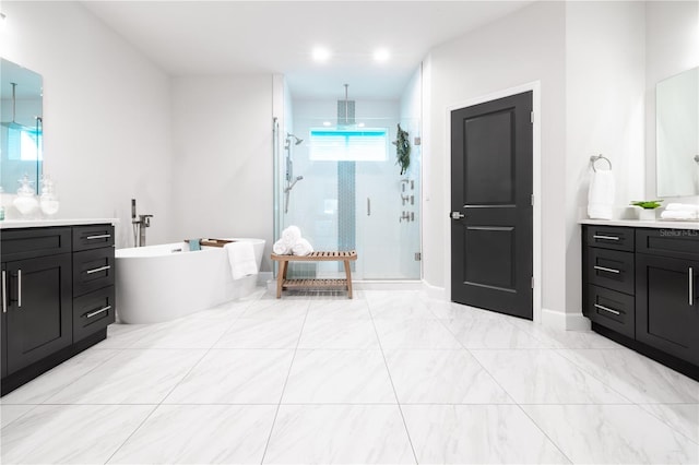 full bath with a shower stall, vanity, a soaking tub, and baseboards