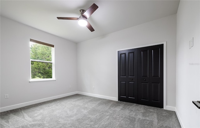 unfurnished bedroom with carpet floors, baseboards, and a ceiling fan
