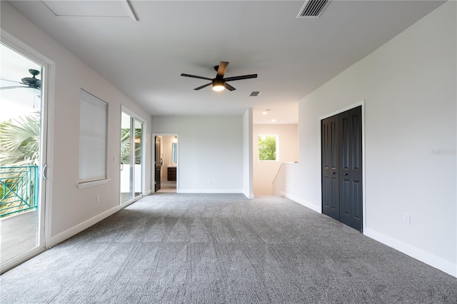 unfurnished room with a ceiling fan, carpet, healthy amount of natural light, and baseboards
