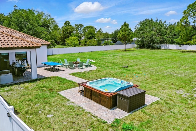 view of yard with a hot tub, a patio area, and view of wooded area