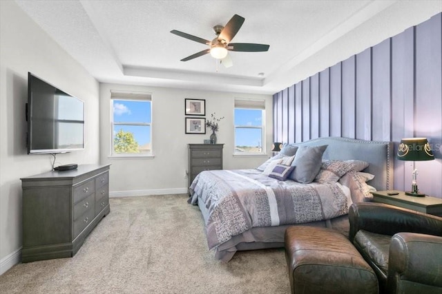 14639 Winter Stay Dr, Winter Garden, FL 34787 - bedroom with baseboards, light carpet, a raised ceiling, and a ceiling fan