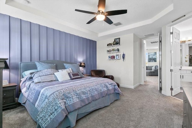 14639 Winter Stay Dr, Winter Garden, FL 34787 - carpeted bedroom with a tray ceiling, baseboards, a ceiling fan, and ensuite bath