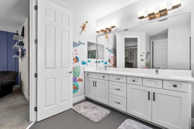 14639 Winter Stay Dr, Winter Garden, FL 34787 - bathroom with double vanity, baseboards, tile patterned flooring, and a textured ceiling