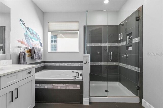14639 Winter Stay Dr, Winter Garden, FL 34787 - bathroom featuring a garden tub, a stall shower, vanity, and tile patterned flooring