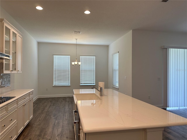 kitchen with dark wood-type flooring, a chandelier, white cabinetry, recessed lighting, and glass insert cabinets