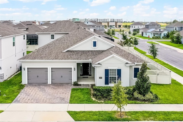 15161 Lake Bessie Loop, Winter Garden, FL 34787 - view of front of house with a residential view, stucco siding, a garage, and a shingled roof