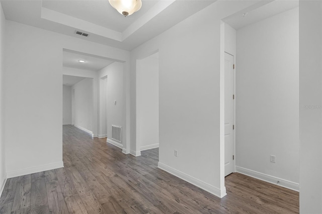 15161 Lake Bessie Loop, Winter Garden, FL 34787 - empty room with wood finished floors, baseboards, and a tray ceiling