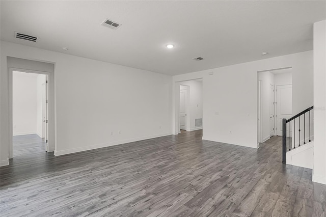 15161 Lake Bessie Loop, Winter Garden, FL 34787 - spare room featuring wood finished floors, stairway, and baseboards