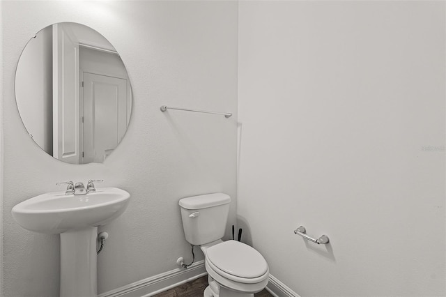 15161 Lake Bessie Loop, Winter Garden, FL 34787 - half bath with toilet, wood finished floors, and baseboards