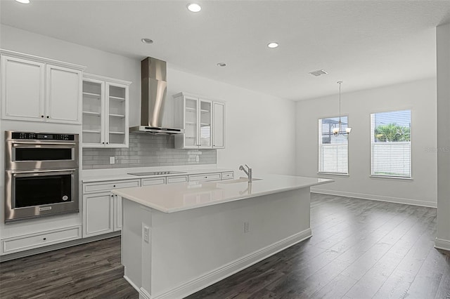 15161 Lake Bessie Loop, Winter Garden, FL 34787 - kitchen with wall chimney exhaust hood, double oven, dark wood-style floors, black electric stovetop, and recessed lighting