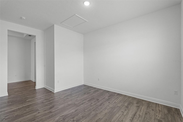 15161 Lake Bessie Loop, Winter Garden, FL 34787 - spare room with dark wood-style flooring, baseboards, attic access, and a smoke detector
