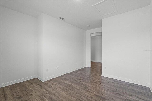 15161 Lake Bessie Loop, Winter Garden, FL 34787 - unfurnished room with attic access, wood finished floors, and baseboards