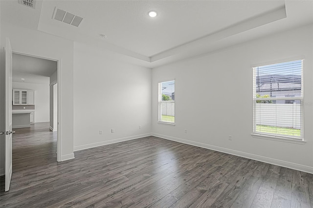 15161 Lake Bessie Loop, Winter Garden, FL 34787 - unfurnished room with dark wood-style flooring, baseboards, a raised ceiling, and recessed lighting