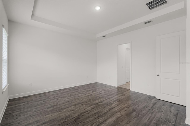 15161 Lake Bessie Loop, Winter Garden, FL 34787 - spare room with dark wood-type flooring, baseboards, recessed lighting, and a tray ceiling