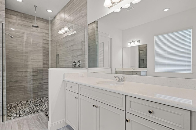 15161 Lake Bessie Loop, Winter Garden, FL 34787 - bathroom featuring a tile shower, vanity, and recessed lighting
