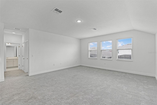 15161 Lake Bessie Loop, Winter Garden, FL 34787 - spare room featuring light carpet, a textured ceiling, baseboards, recessed lighting, and vaulted ceiling