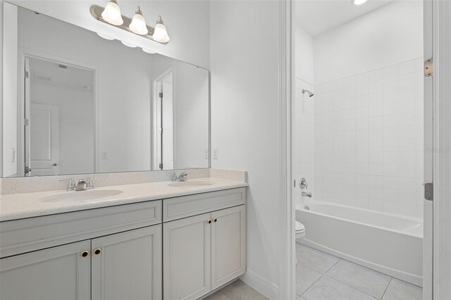 15161 Lake Bessie Loop, Winter Garden, FL 34787 - bathroom with double vanity, toilet, tile patterned flooring, shower / bathtub combination, and baseboards