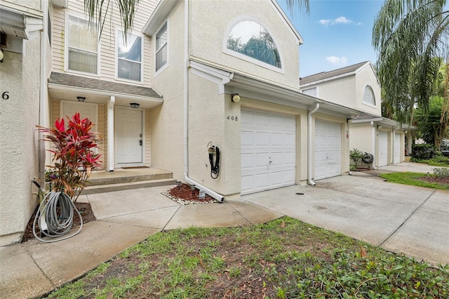 6057 Lake Pointe Dr Unit 408, Orlando, FL 32822 - view of side of home featuring concrete driveway, stucco siding, and an attached garage