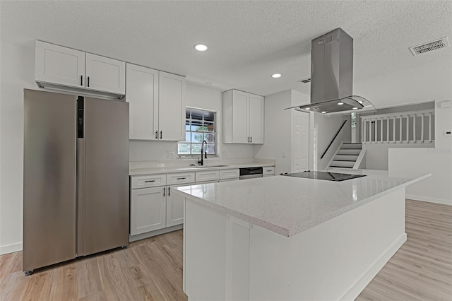 7085 Willowwood St, Orlando, FL 32818 - kitchen with stainless steel appliances, a sink, island exhaust hood, white cabinets, and light wood finished floors