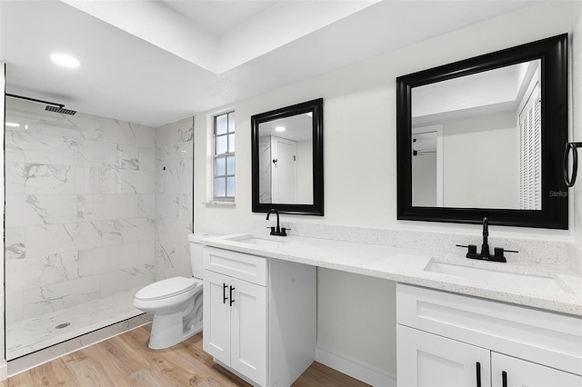 7085 Willowwood St, Orlando, FL 32818 - bathroom featuring tiled shower, double vanity, and wood finished floors