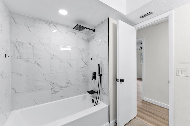 7085 Willowwood St, Orlando, FL 32818 - bathroom featuring  shower combination, baseboards, wood finished floors, and recessed lighting