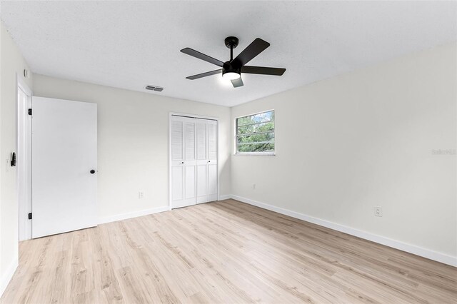 7085 Willowwood St, Orlando, FL 32818 - unfurnished bedroom featuring light wood-style flooring, baseboards, a closet, and ceiling fan
