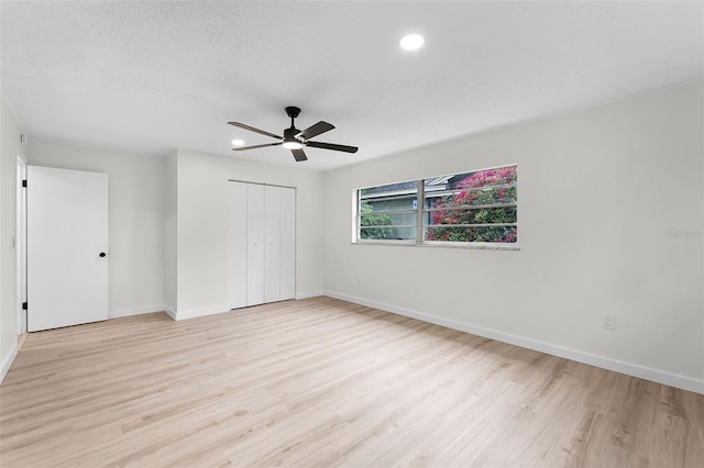 7085 Willowwood St, Orlando, FL 32818 - unfurnished bedroom featuring light wood finished floors, baseboards, a closet, and recessed lighting